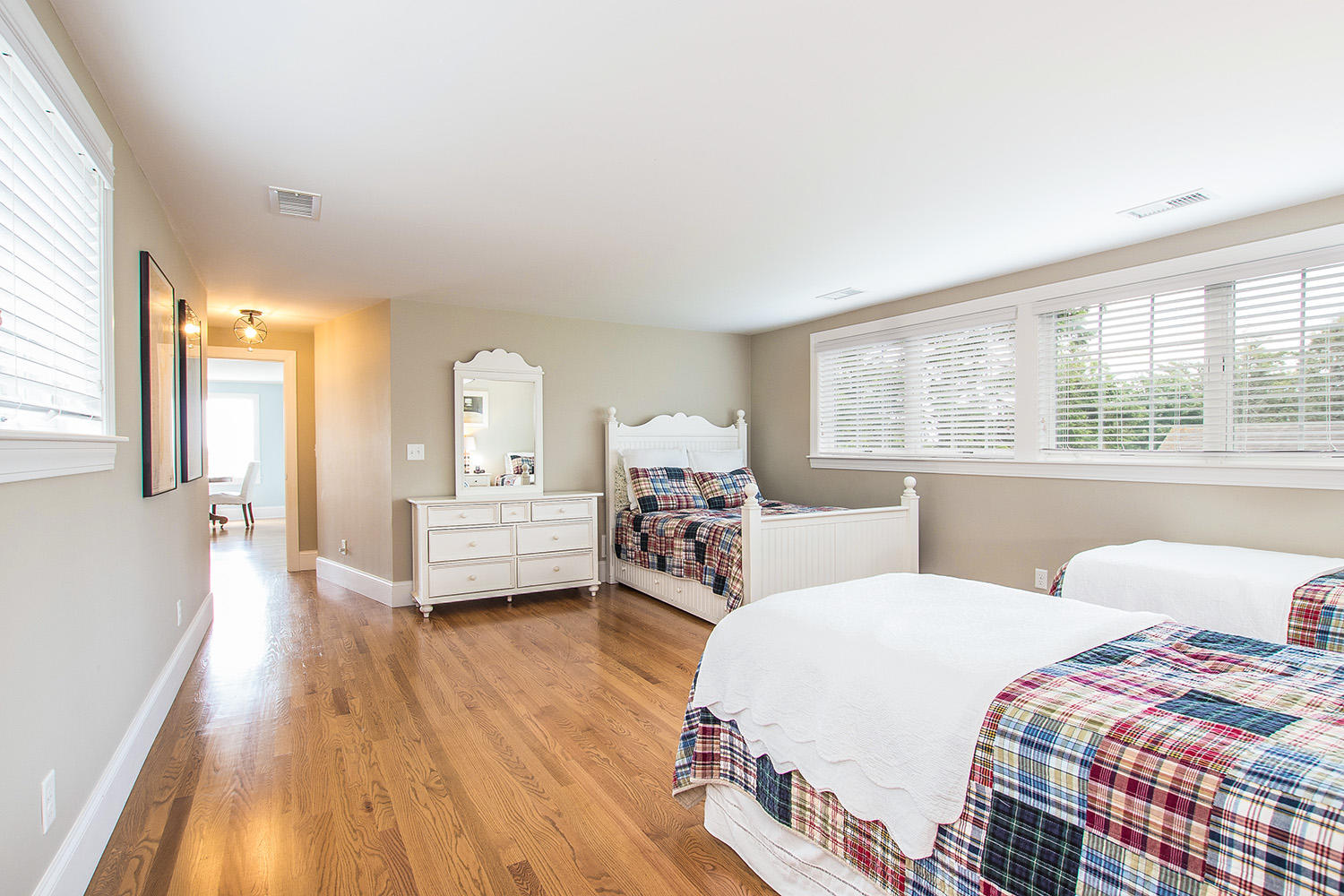107 Captains Walk Chatham, MA 02650 - Photo 40 of 51 a bedroom with two beds and a large mirror next to a window