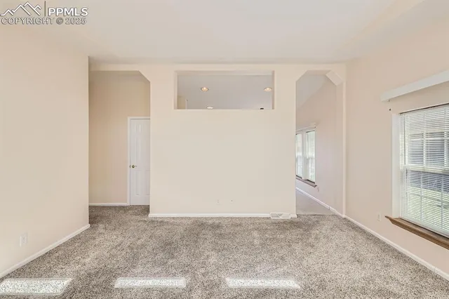 a kitchen with a sink a refrigerator and cabinets