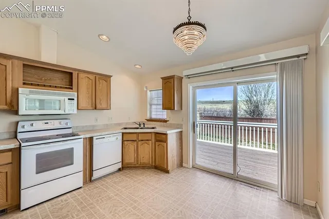 a kitchen with stainless steel appliances a refrigerator and a wooden floor