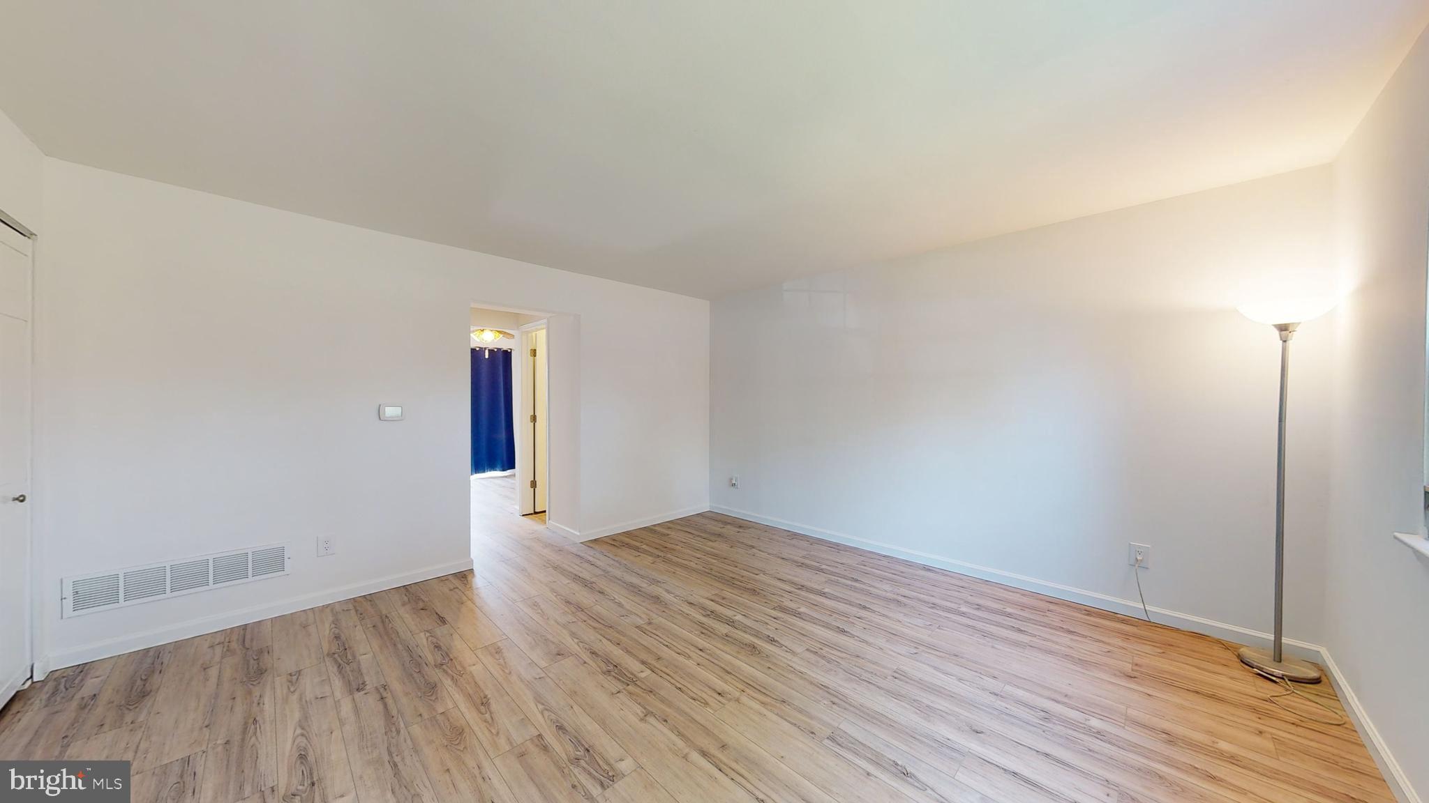 49 Eaves Mill Road Medford, NJ 08055 - Photo 11 of 38 an empty room with wooden floor and windows