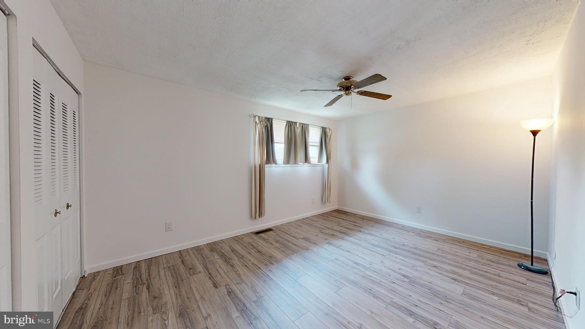 49 Eaves Mill Road Medford, NJ 08055 - Photo 12 of 38 a view of an empty room with a window and wooden floor
