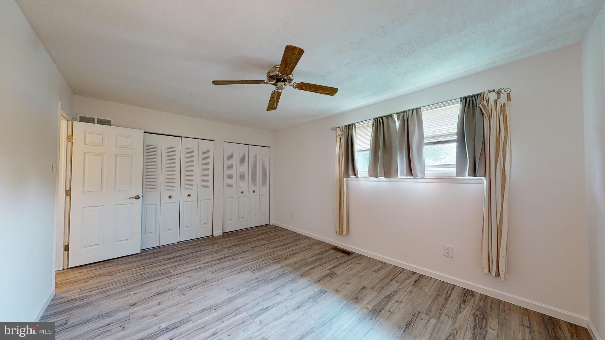 49 Eaves Mill Road Medford, NJ 08055 - Photo 13 of 38 a view of empty room with wooden floor and fan