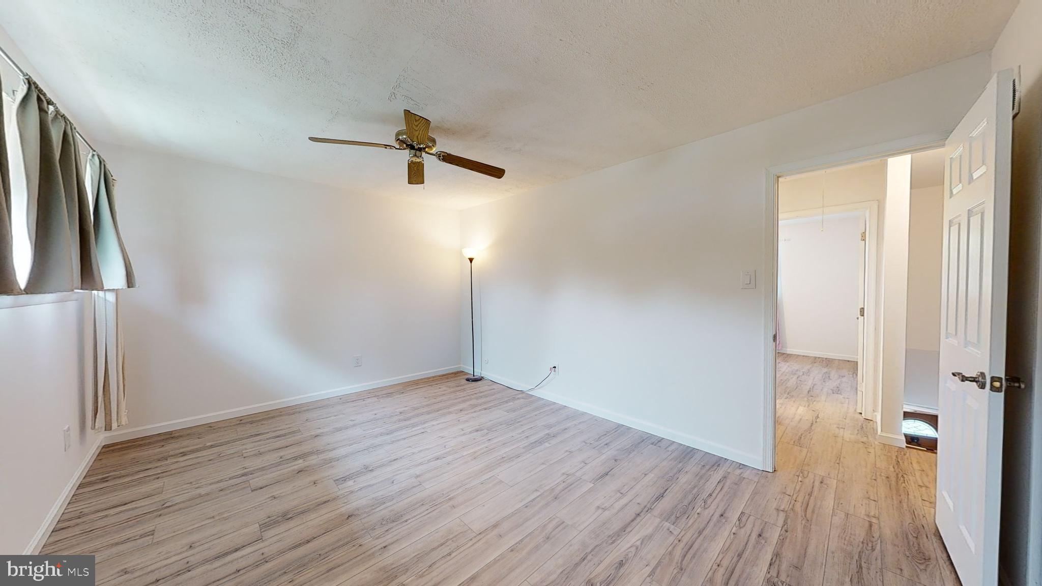 49 Eaves Mill Road Medford, NJ 08055 - Photo 15 of 38 an empty room with wooden floor and windows