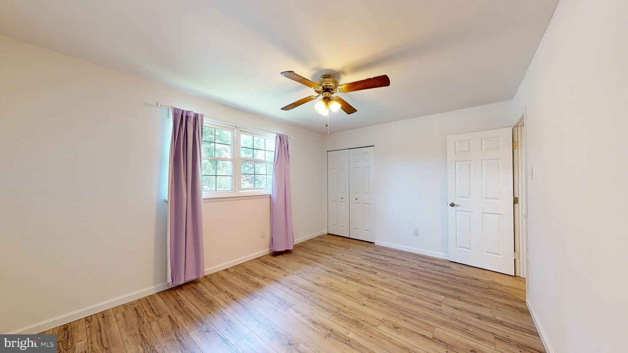 49 Eaves Mill Road Medford, NJ 08055 - Photo 20 of 38 an empty room with wooden floor and windows