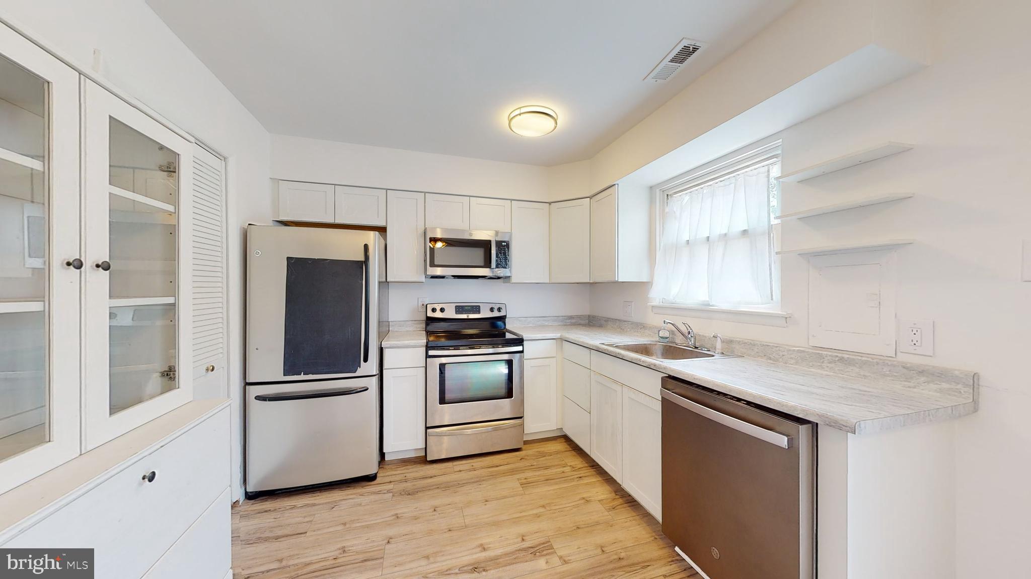 49 Eaves Mill Road Medford, NJ 08055 - Photo 2 of 38 a kitchen with stainless steel appliances granite countertop a refrigerator a sink a stove a microwave and island