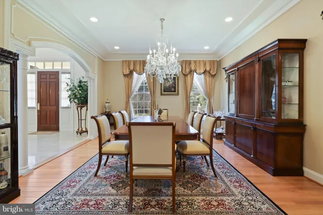 a living room with furniture a large window and stainless steel appliances