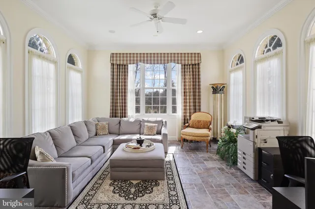 a view of a dining room with furniture a chandelier and wooden floor