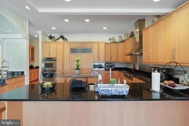 a bathroom with a granite countertop sink a toilet and bathtub