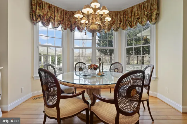 a kitchen with stainless steel appliances kitchen island granite countertop a refrigerator and cabinets