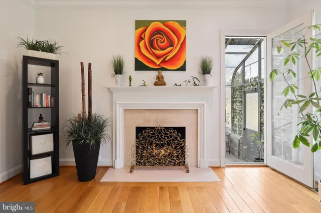a front view of a house with a garden and trees