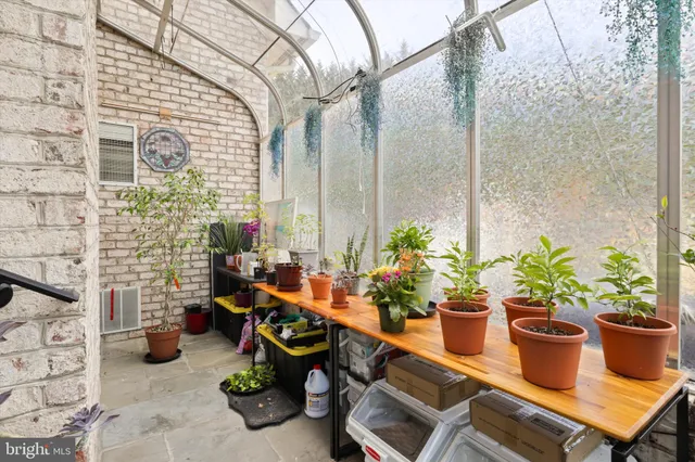 a view of a patio with table and chairs potted plants with wooden floor and fence