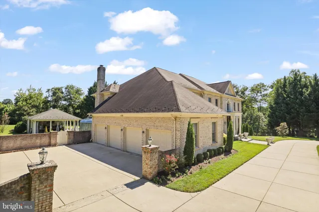 a living room with furniture a chandelier and a large mirror