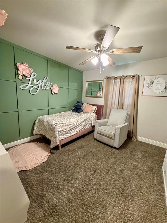 619 Mansfield Road Cleburne, TX 76031 - Photo 6 of 19 Green accent wall featuring vertical and horizontal paneling