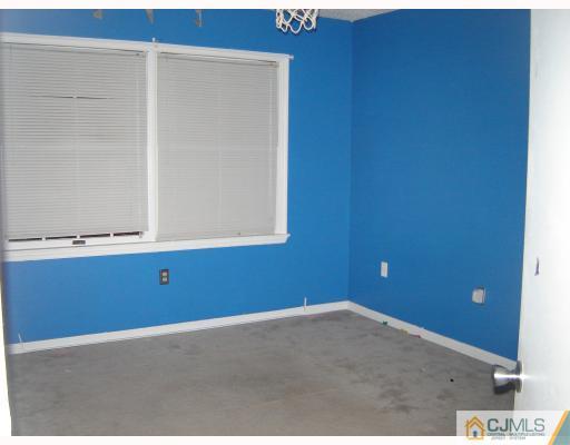 1224 Edpas Road New Brunswick, NJ 08901 - Photo 6 of 6 an empty room with wooden floor and cabinets