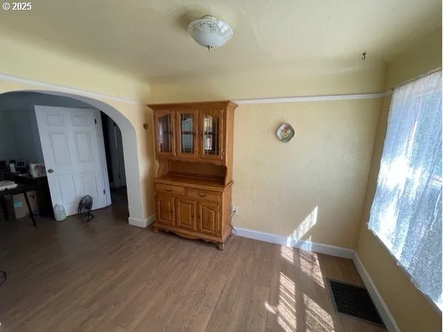 a view of a livingroom with furniture and hardwood floor