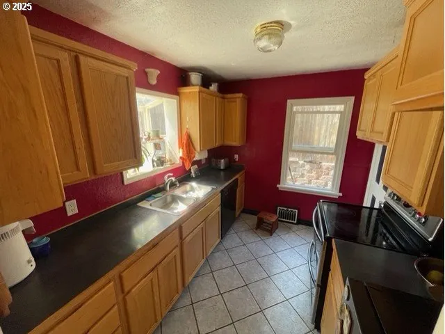 a kitchen with a large window and cabinets