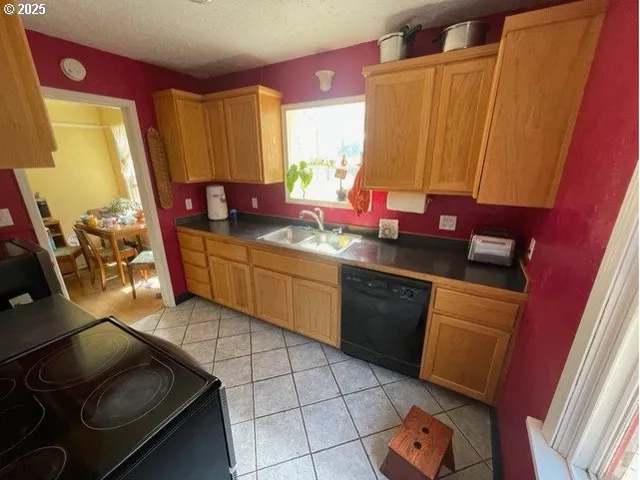 a kitchen with stainless steel appliances a sink stove and cabinets
