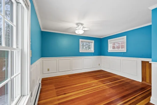 a view of a room with wooden floor and fan