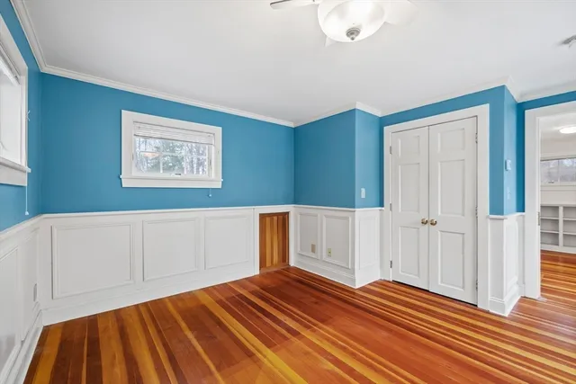 a view of a room with wooden floor and cabinet