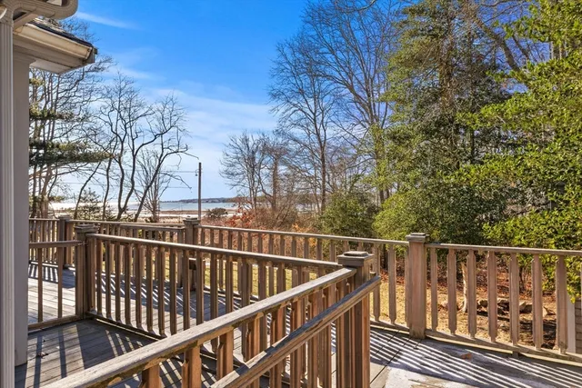 a view of balcony with wooden floor and fence