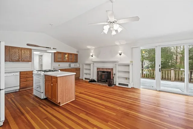 a view of a kitchen with furniture fireplace and wooden floor