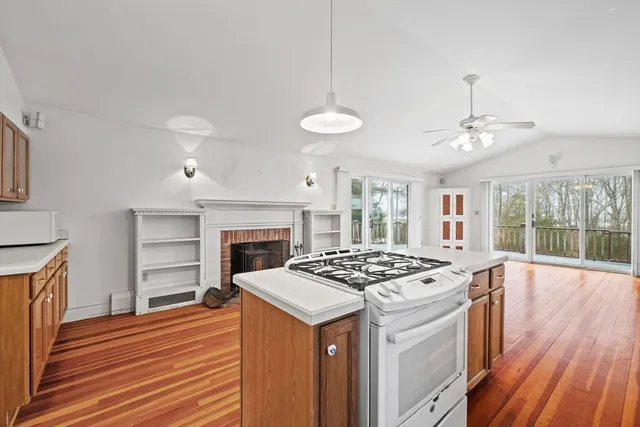 a kitchen that has a stove and a wooden floor