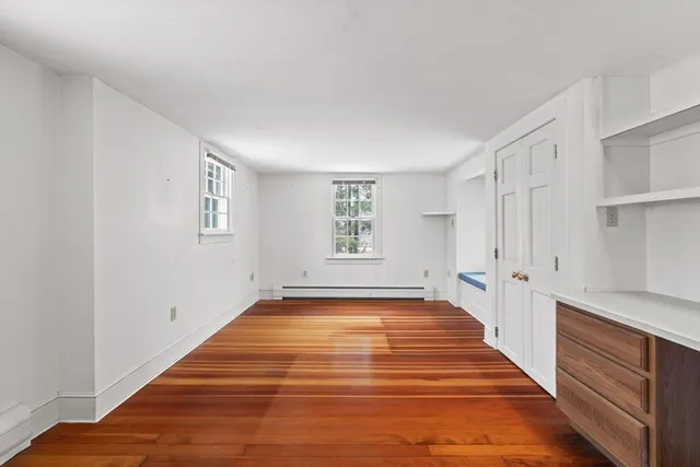 a view of a livingroom with wooden floor and staircase