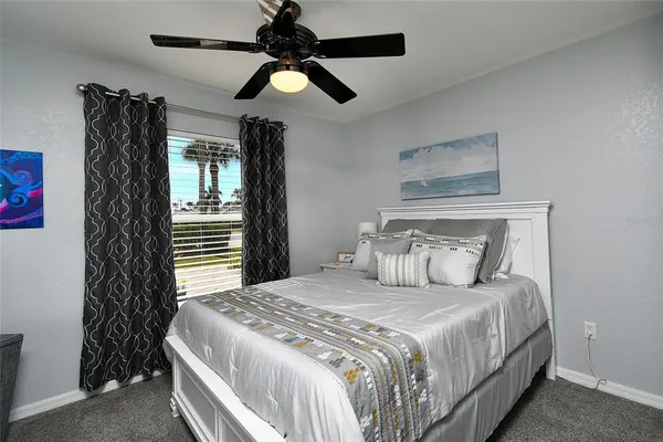 a bedroom with a large bed and a chandelier