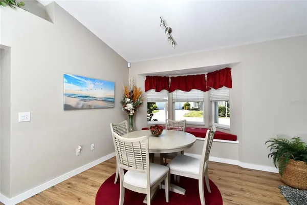 a view of a dining room with furniture window and wooden floor