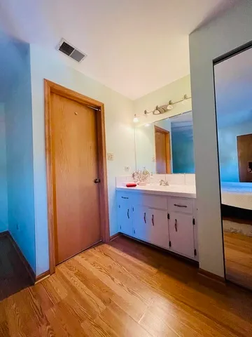 a spacious bathroom with a double vanity sink and a mirror