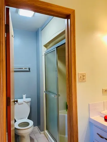 a bathroom with a toilet and a shower
