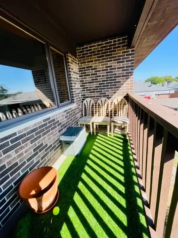 a balcony with wooden floor and outdoor seating