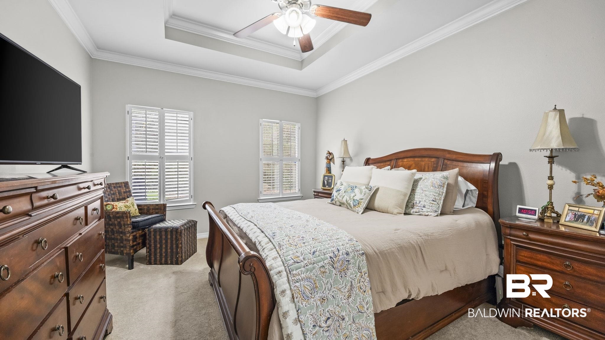 1090 Melbourne Court Foley, AL 36535 - Photo 29 of 38 Bedroom featuring light colored carpet, ceiling fan, ornamental molding, and a raised ceiling