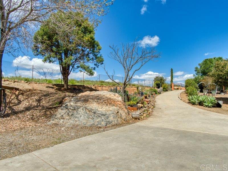 13913 Via De Jamul Jamul Ca Jamul, CA 91935 - Photo 43 of 67 a view of a yard with table and chairs