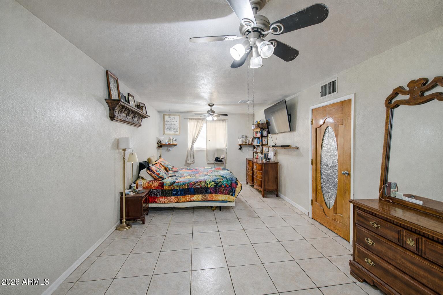 3107 West Montebello Avenue Phoenix, AZ 85017 - Photo 15 of 30 a bedroom with a bed and a chandelier
