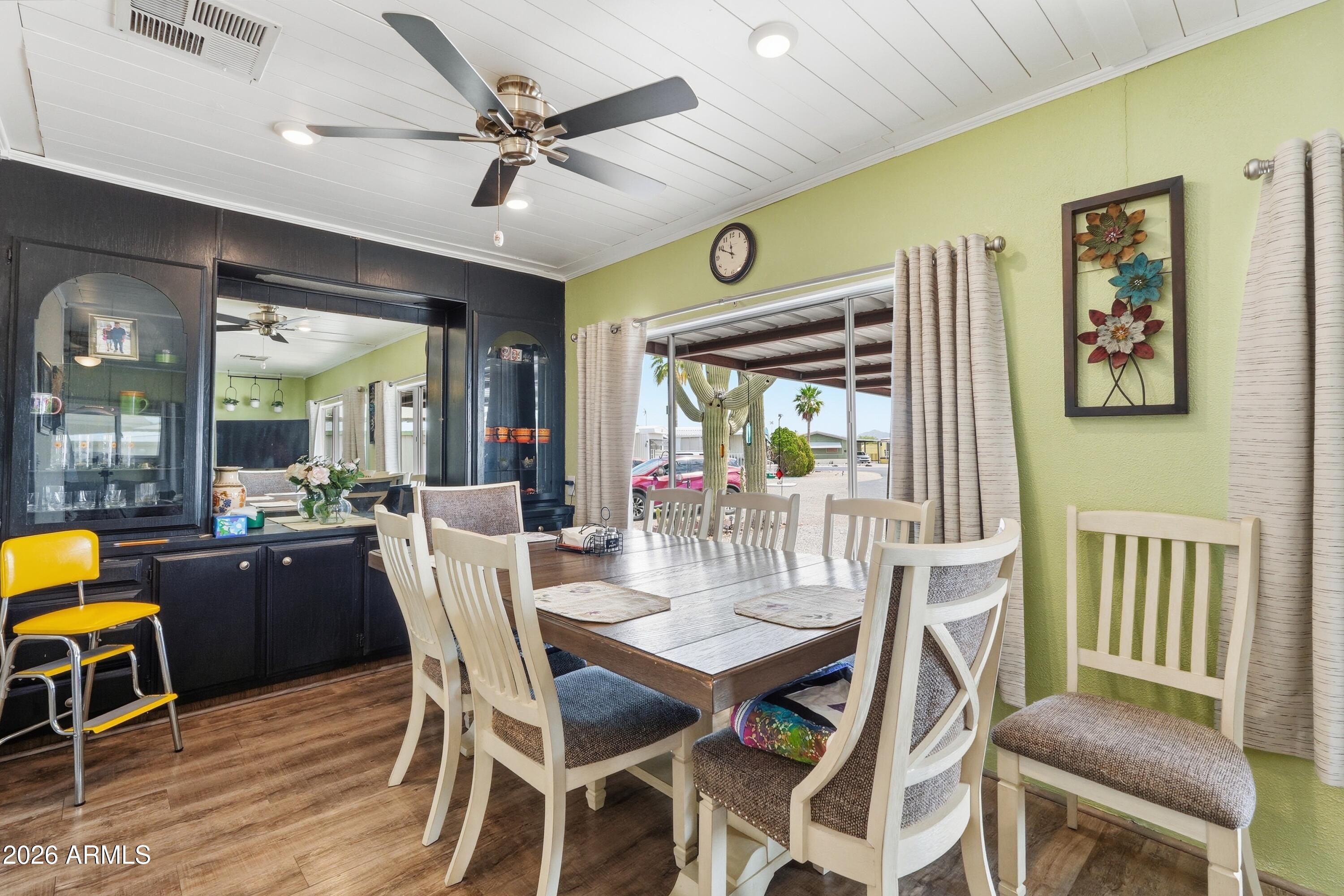11100 West Alsdorf Road, Unit 50 Arizona City, AZ 85123 - Photo 10 of 36 a view of a dining room with furniture window and wooden floor