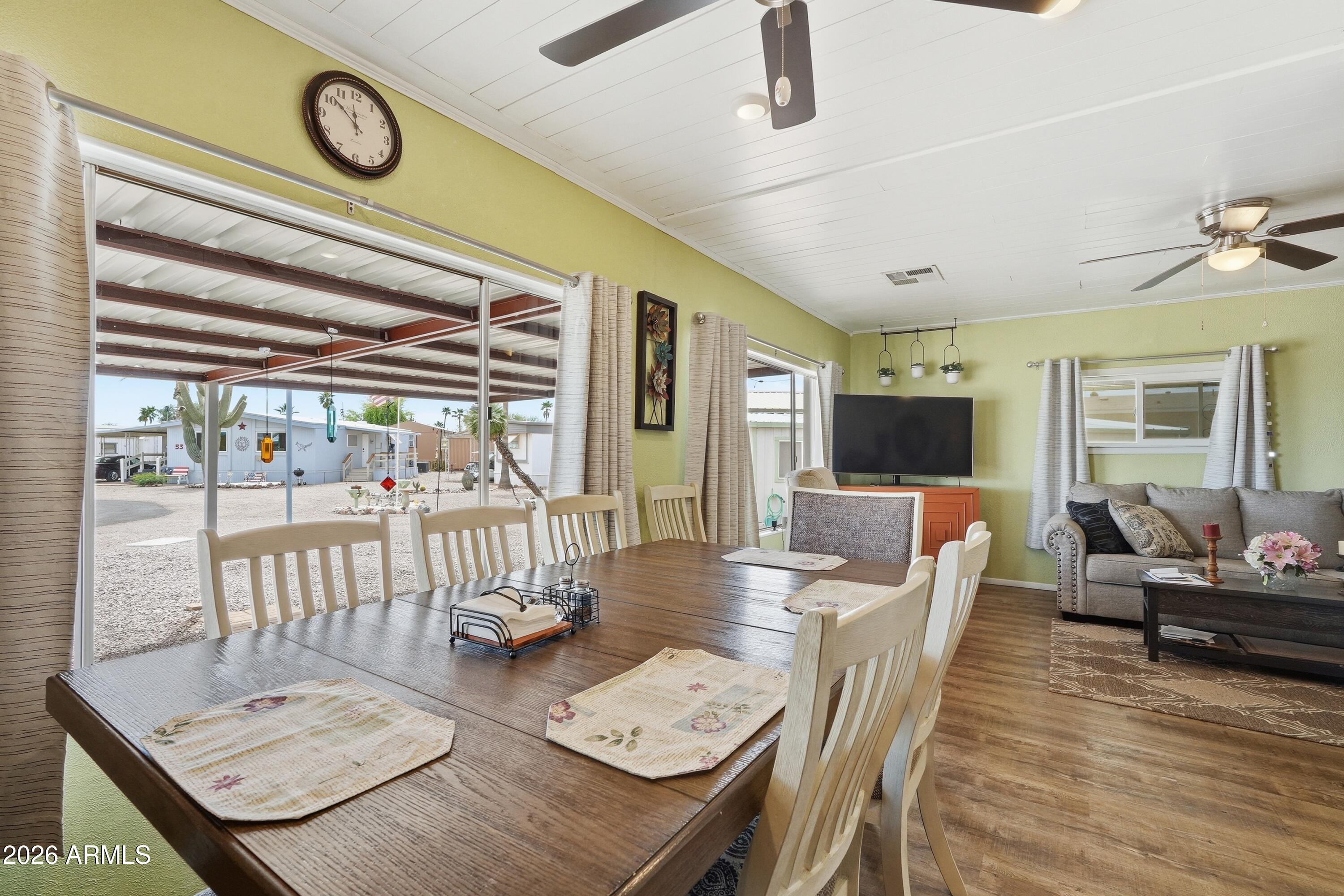 11100 West Alsdorf Road, Unit 50 Arizona City, AZ 85123 - Photo 11 of 36 a view of a dining room with furniture wooden floor and chandelier