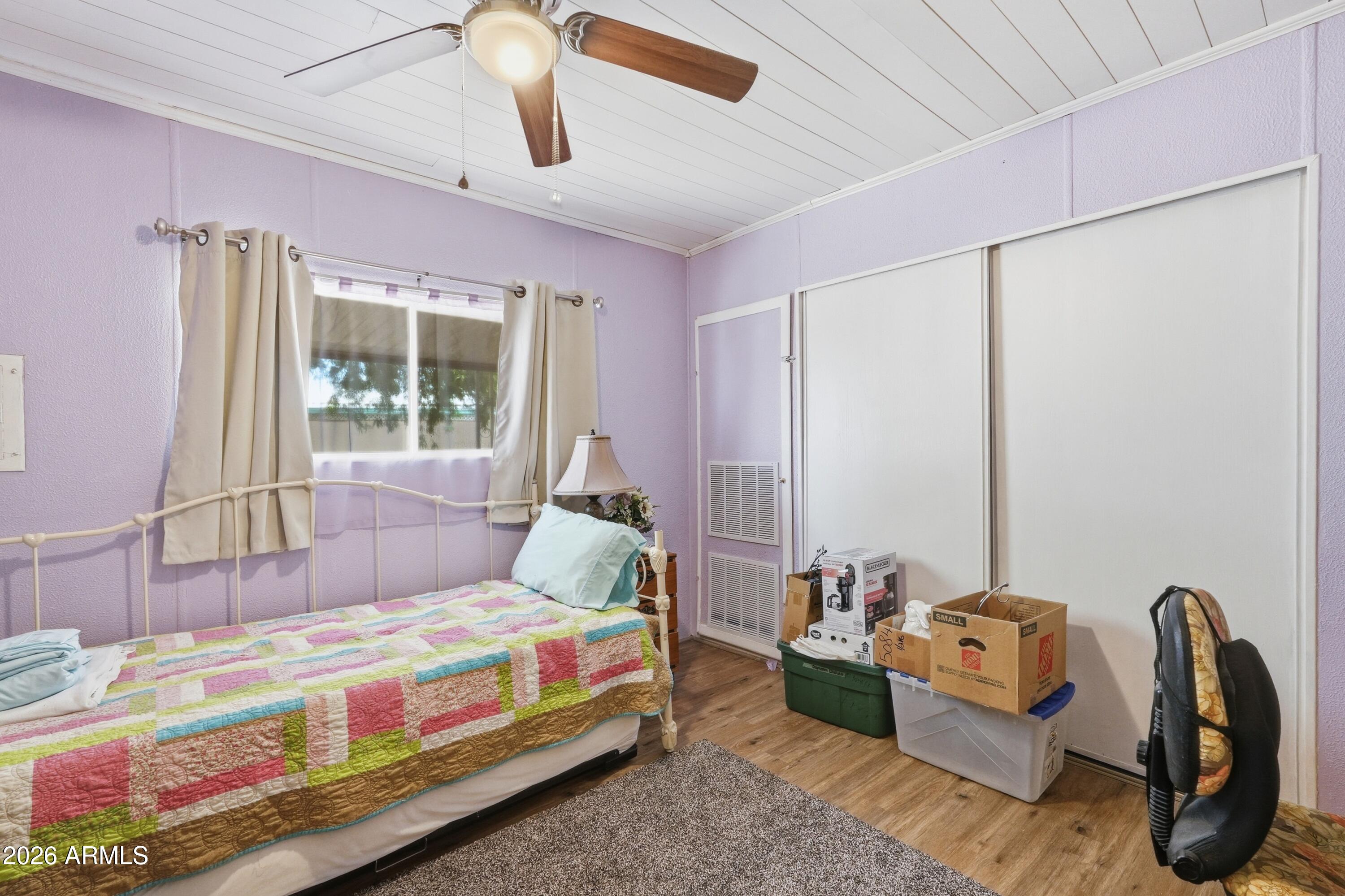 11100 West Alsdorf Road, Unit 50 Arizona City, AZ 85123 - Photo 15 of 36 a bedroom with furniture and a large window