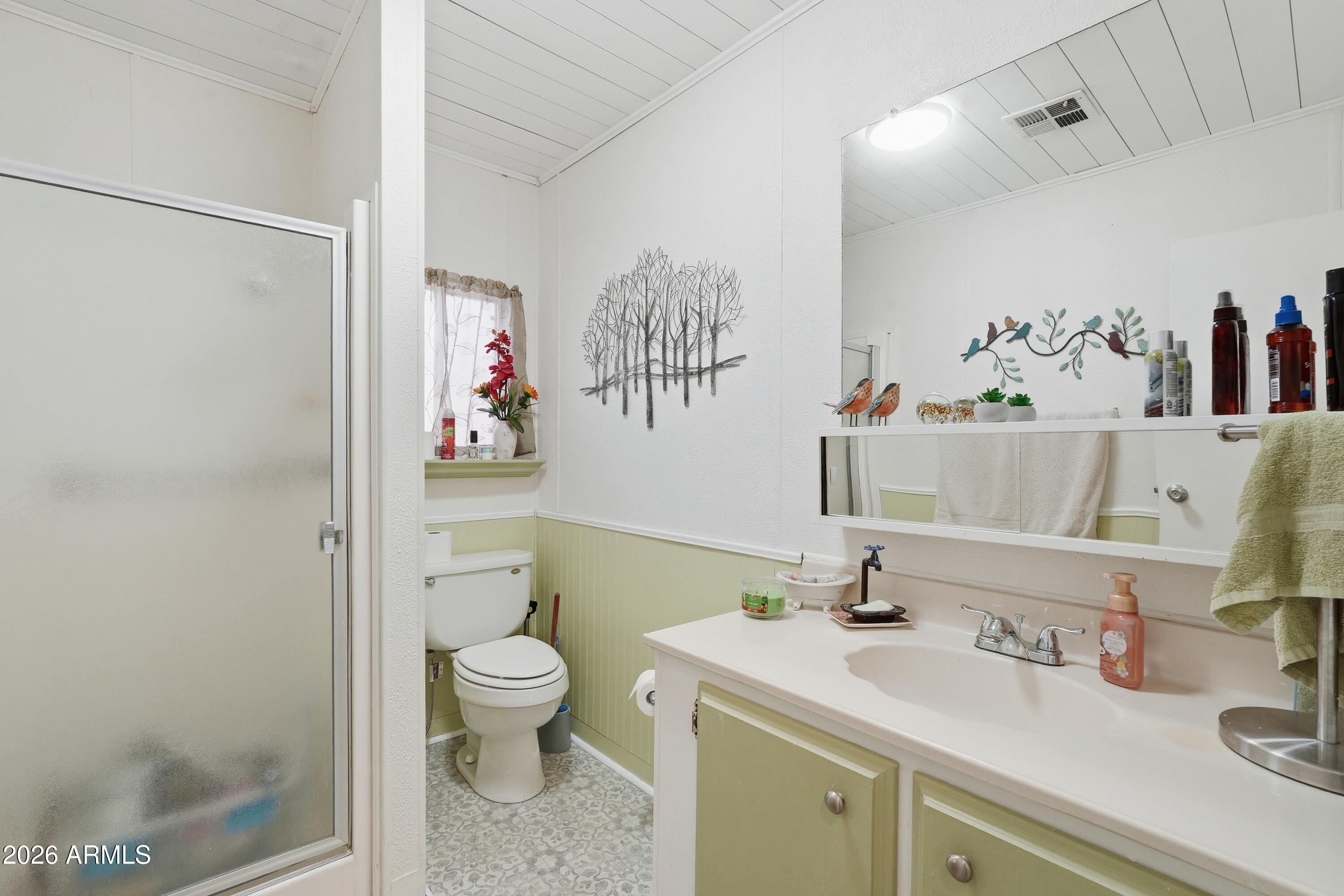 11100 West Alsdorf Road, Unit 50 Arizona City, AZ 85123 - Photo 16 of 36 a bathroom with a sink a toilet and a mirror
