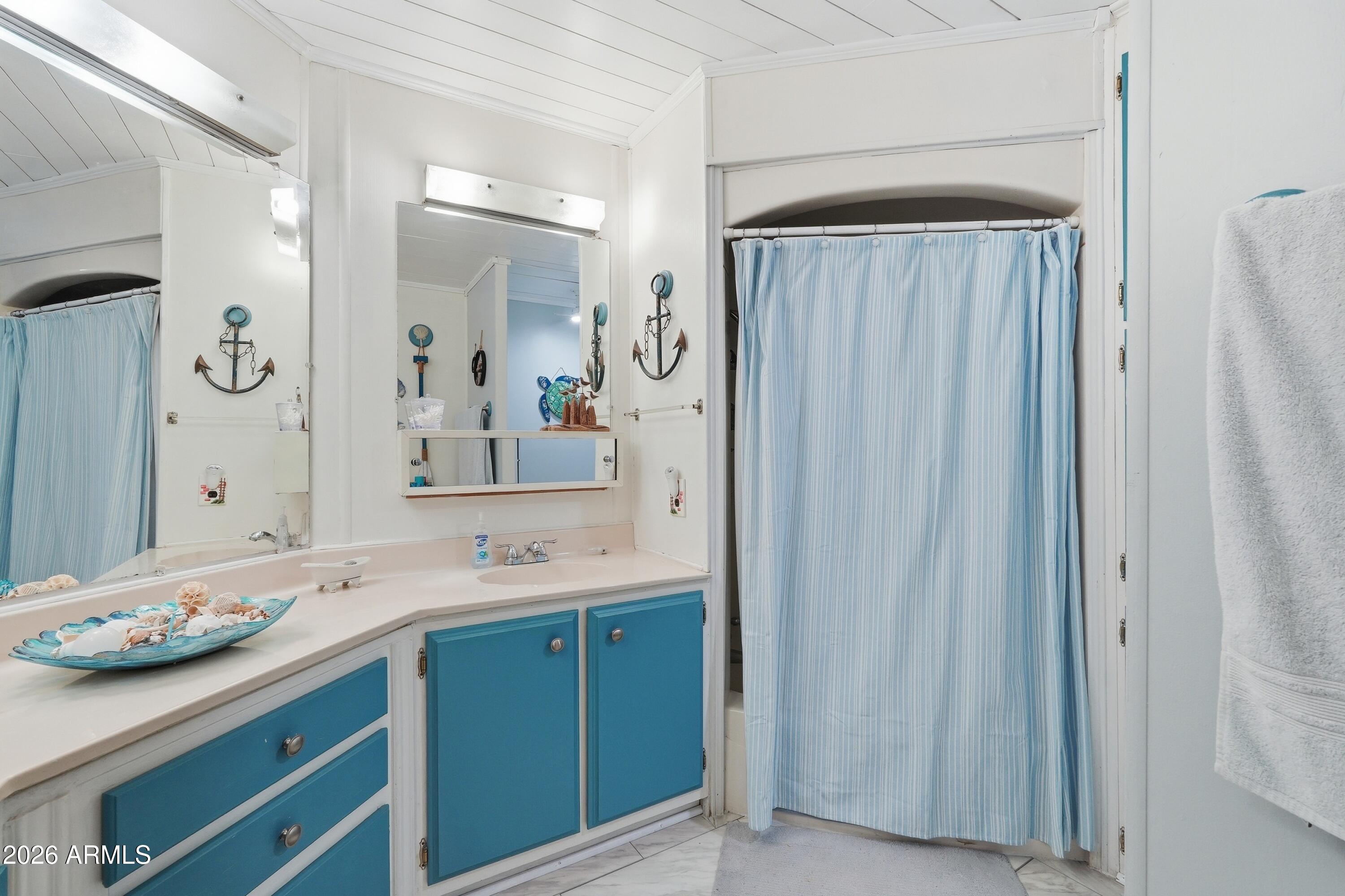11100 West Alsdorf Road, Unit 50 Arizona City, AZ 85123 - Photo 21 of 36 a bathroom with a sink and a mirror