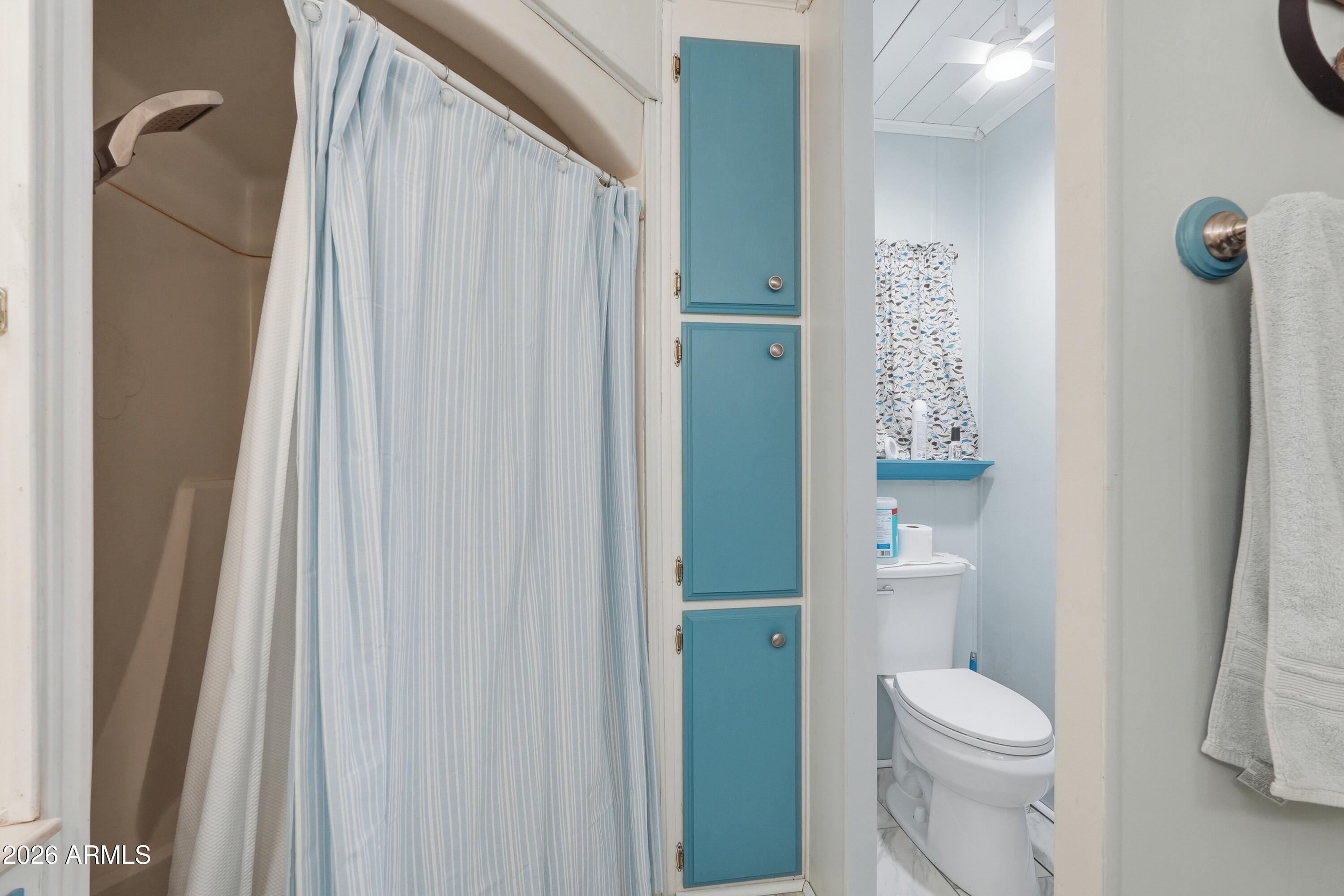 11100 West Alsdorf Road, Unit 50 Arizona City, AZ 85123 - Photo 23 of 36 a white toilet sitting next to a bathroom sink and a shower