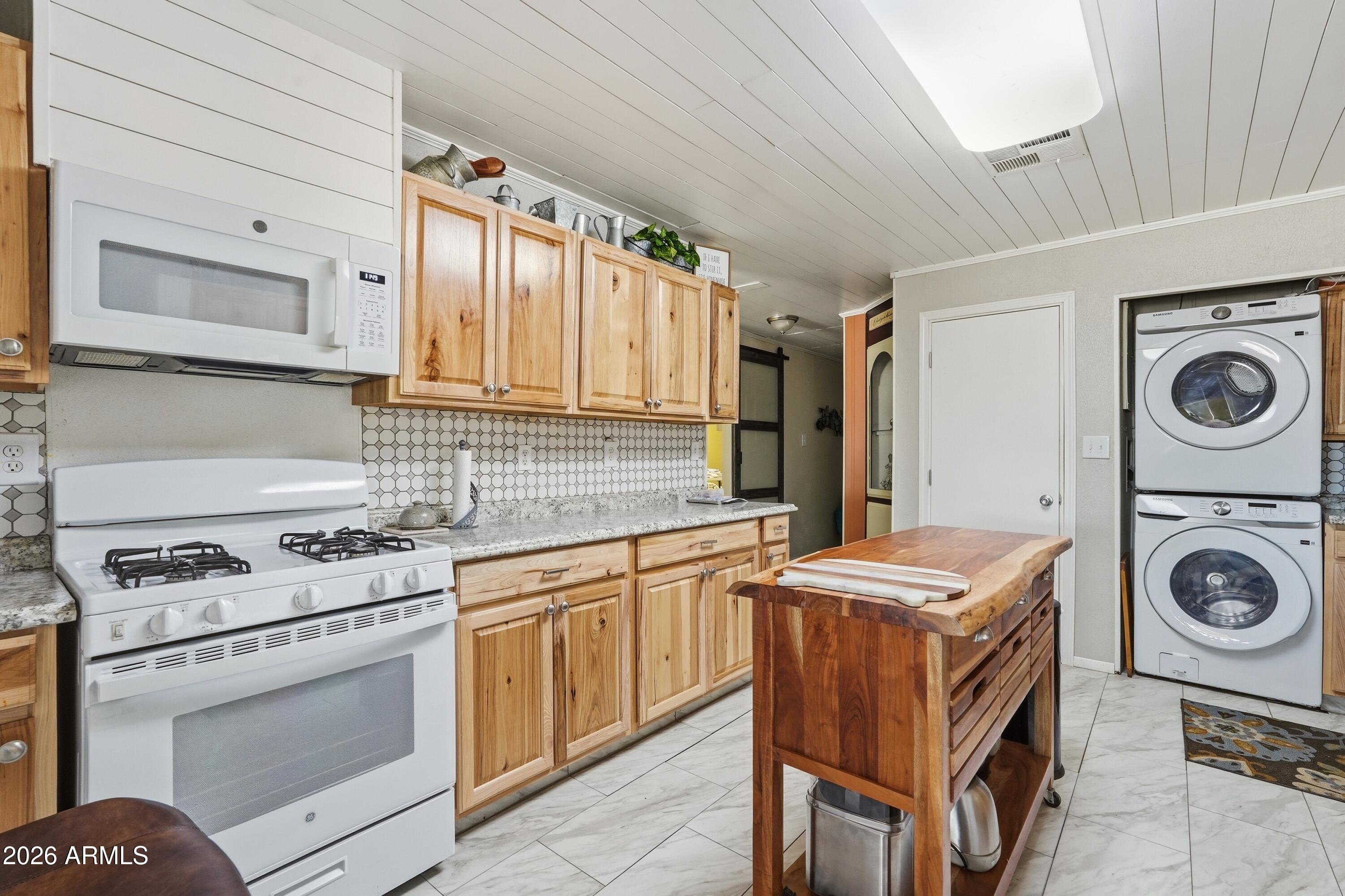 11100 West Alsdorf Road, Unit 50 Arizona City, AZ 85123 - Photo 24 of 36 a kitchen with a stove top oven sink and cabinets
