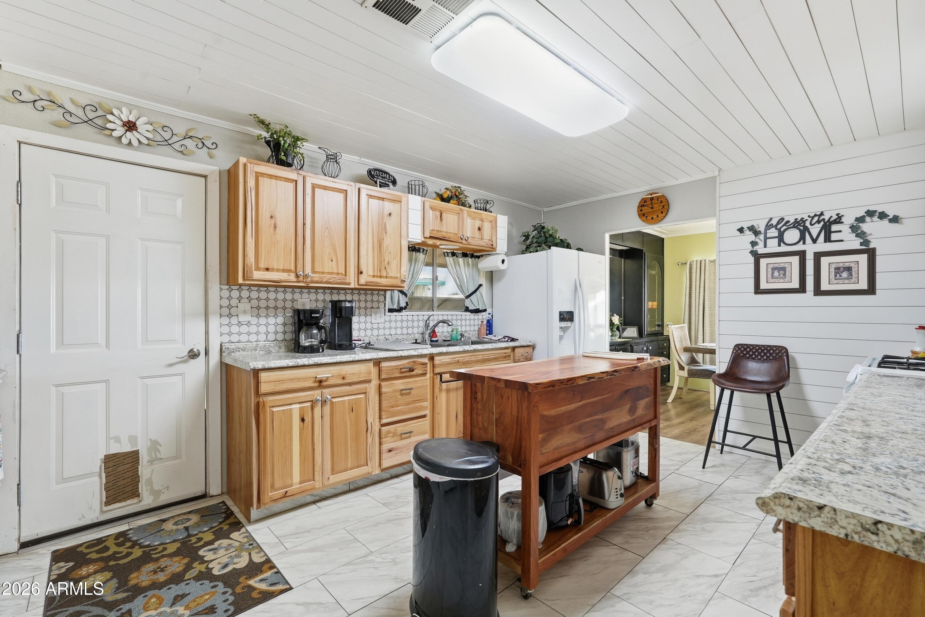 11100 West Alsdorf Road, Unit 50 Arizona City, AZ 85123 - Photo 8 of 36 a kitchen with stainless steel appliances granite countertop a stove a sink dishwasher and cabinets with wooden floor