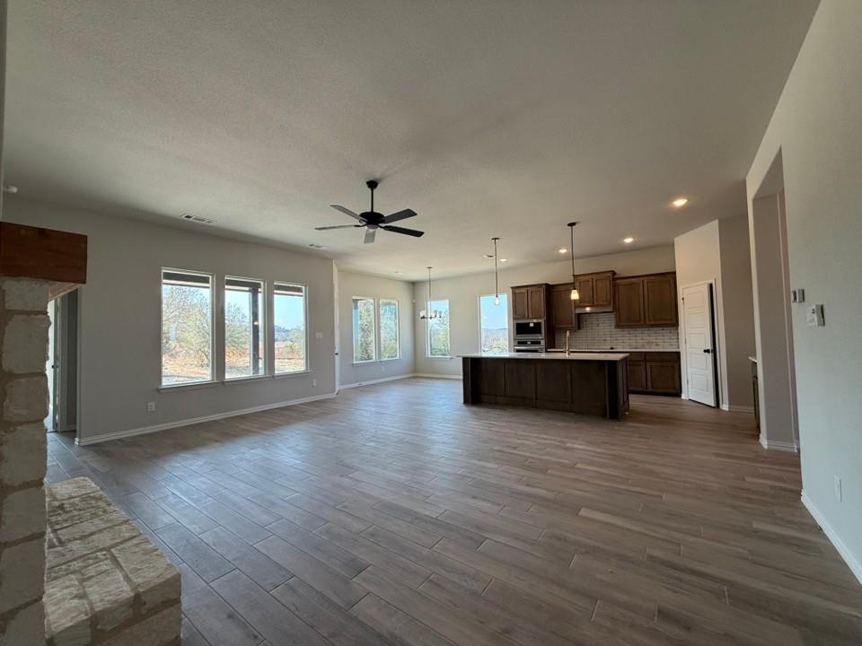 409 Hayden Faith Court Springtown, TX 76082 - Photo 12 of 23 a view of kitchen with wooden floor and window