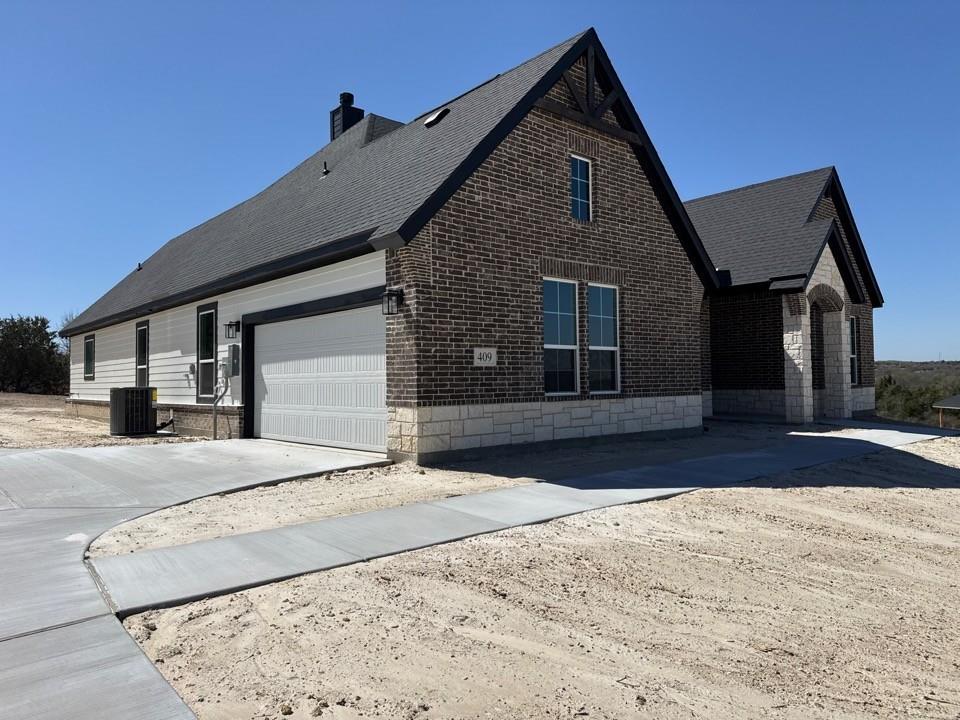 409 Hayden Faith Court Springtown, TX 76082 - Photo 4 of 23 a front view of a house with a yard