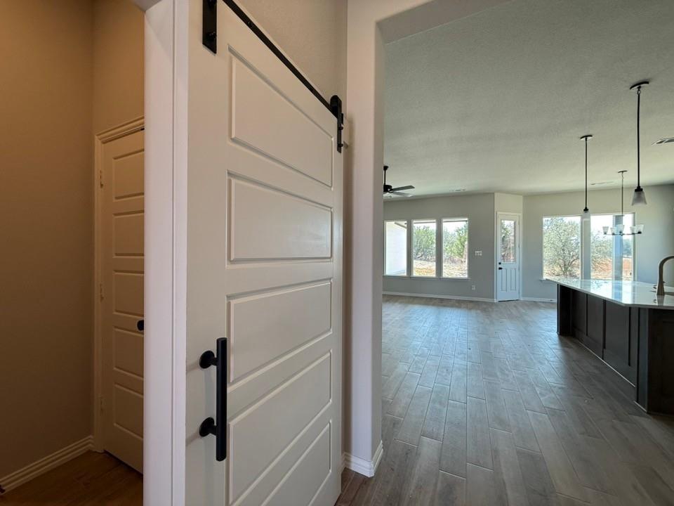 409 Hayden Faith Court Springtown, TX 76082 - Photo 10 of 23 a view of a hallway with wooden floor and staircase