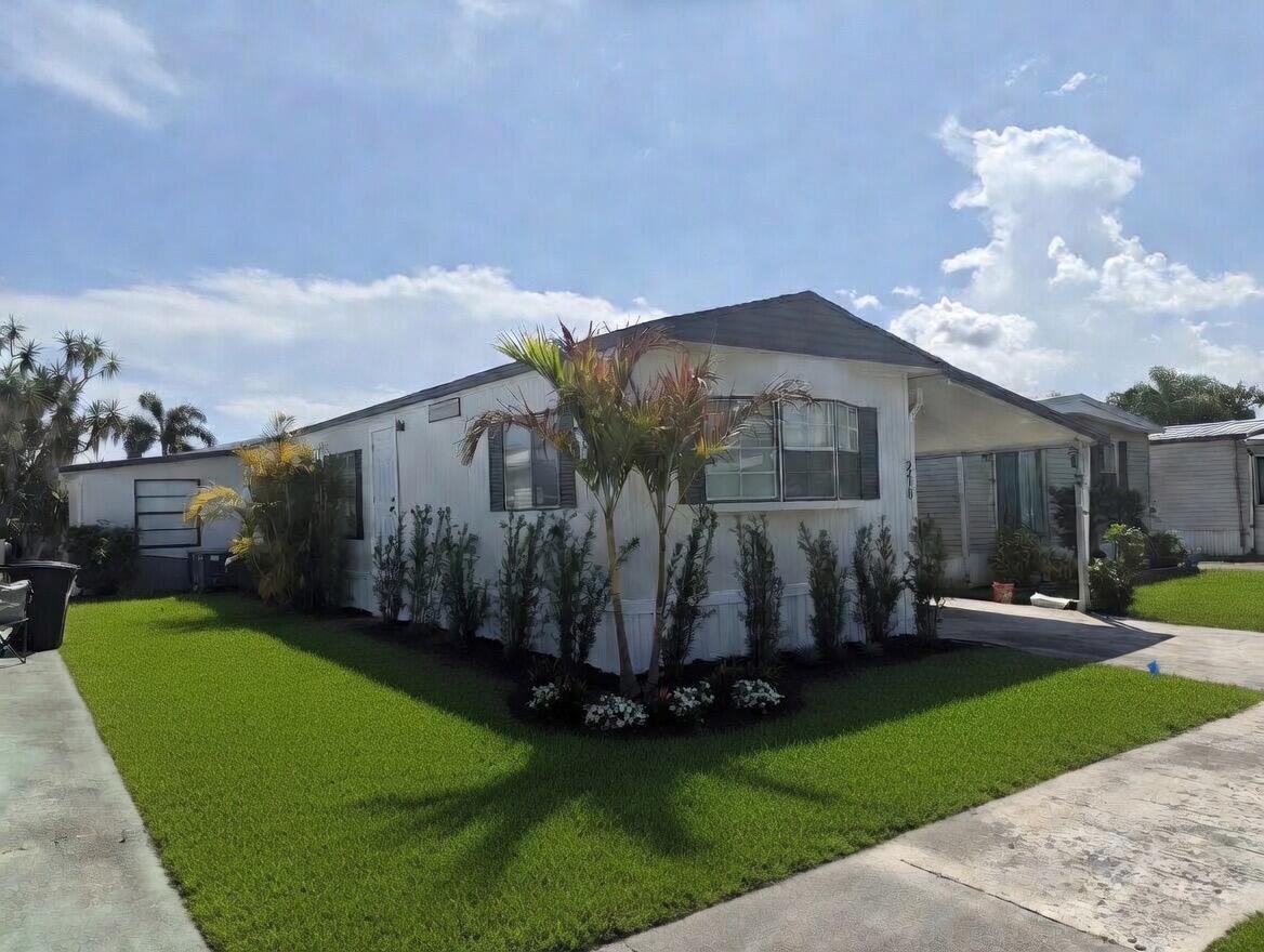 2410 Southwest 50th Street Dania Beach, FL 33312 - Photo 2 of 14 a front view of a house with garden
