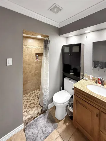 a bathroom with a sink a toilet a mirror and shower