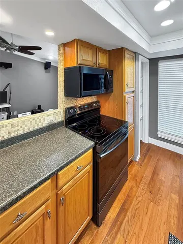 a kitchen with granite countertop a sink and a stove top oven