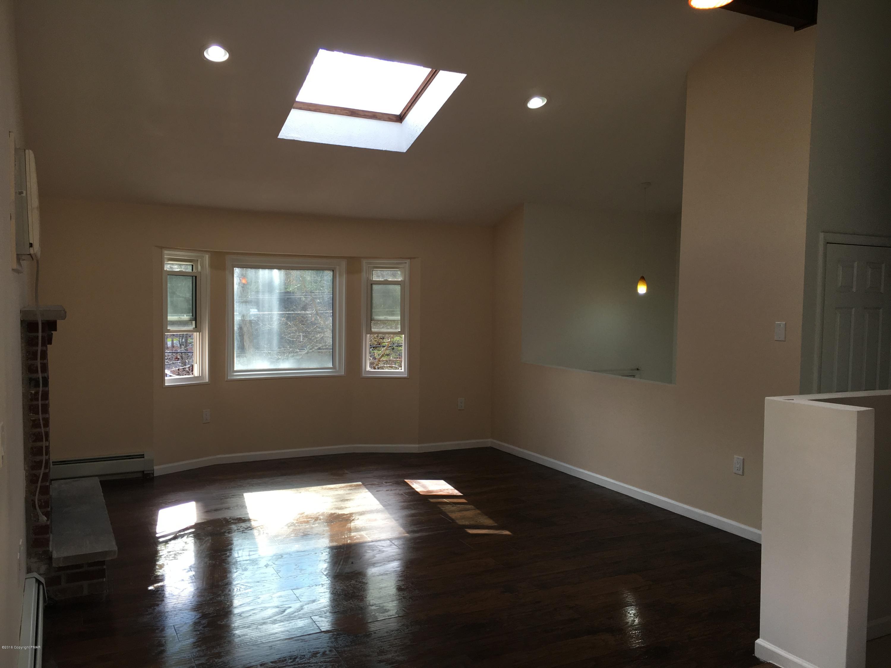 6229 Decker Road Bushkill, PA 18324 - Photo 5 of 15 a view of empty room with wooden floor and fan